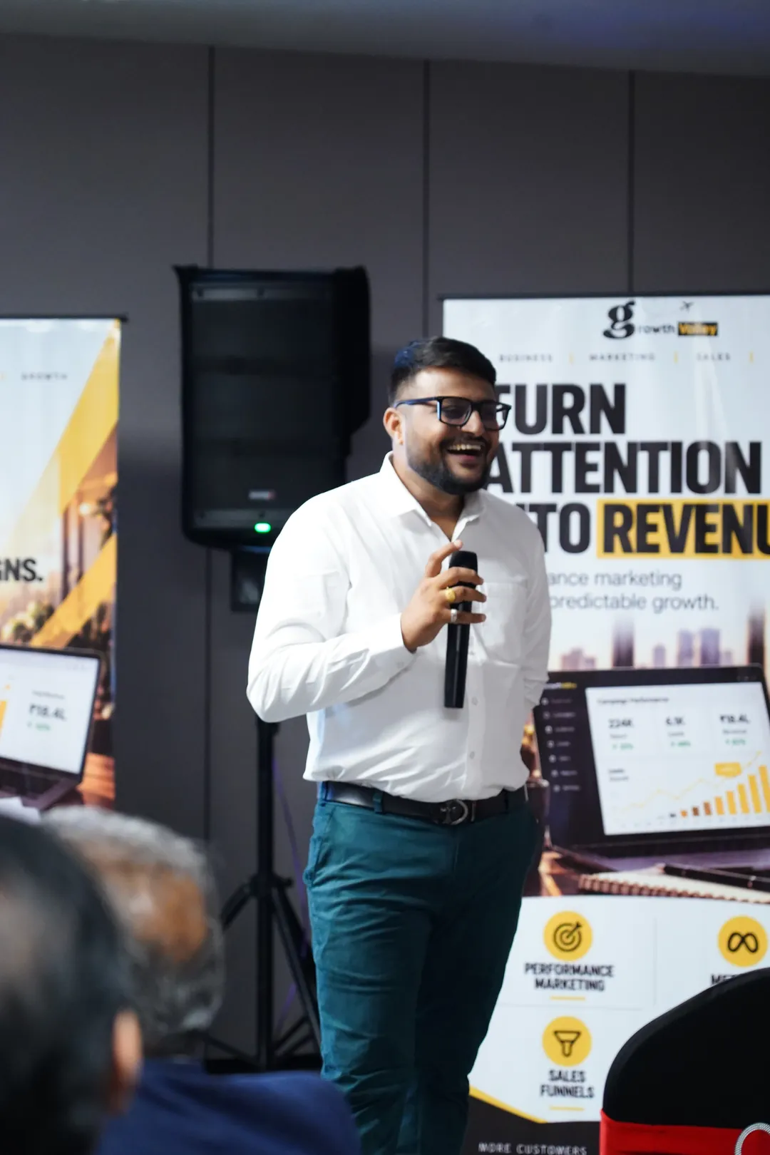 Umesh Khivasara smiling while speaking at a business session