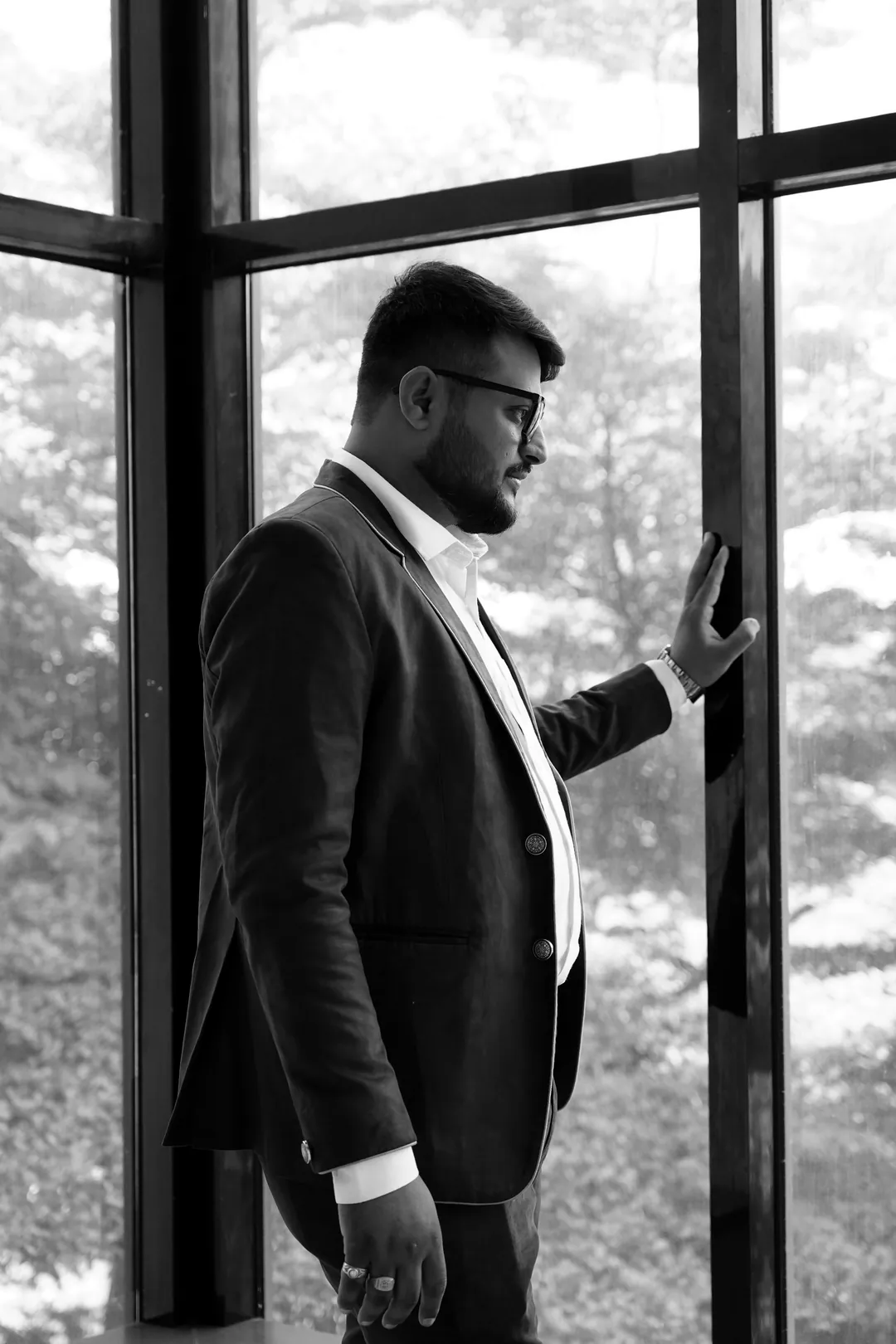 Black-and-white portrait of Umesh Khivasara at a tall window