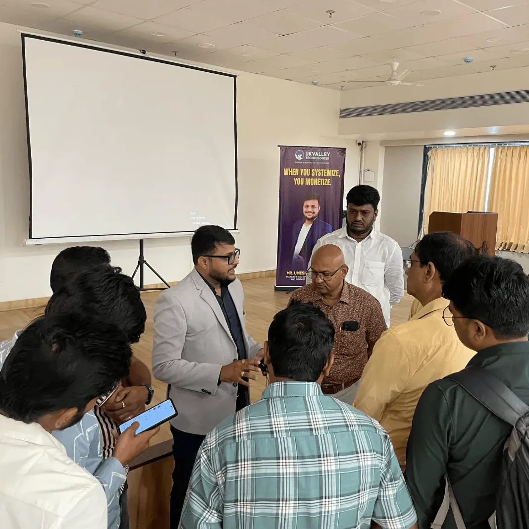 Umesh Khivasara talking with business owners after a workshop session